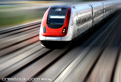 Train speeding along its tracks with motion blur.